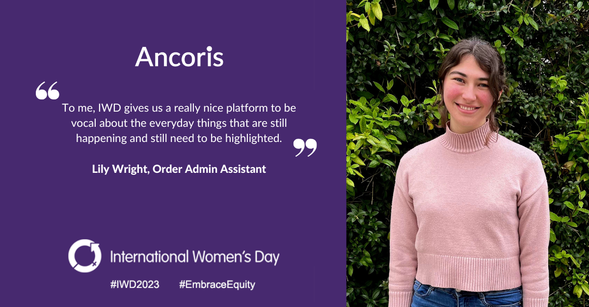 Medium shot of brunette woman in pink jumper besides white text quoting about their what International Women's Day means to them. The image and text are set across a purple background specifically for International Women's Day.