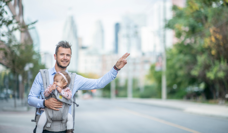 Young father waiting for a private hire car
