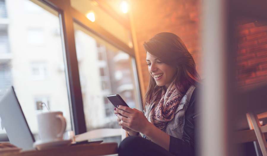 Young woman using Google Drive on her phone