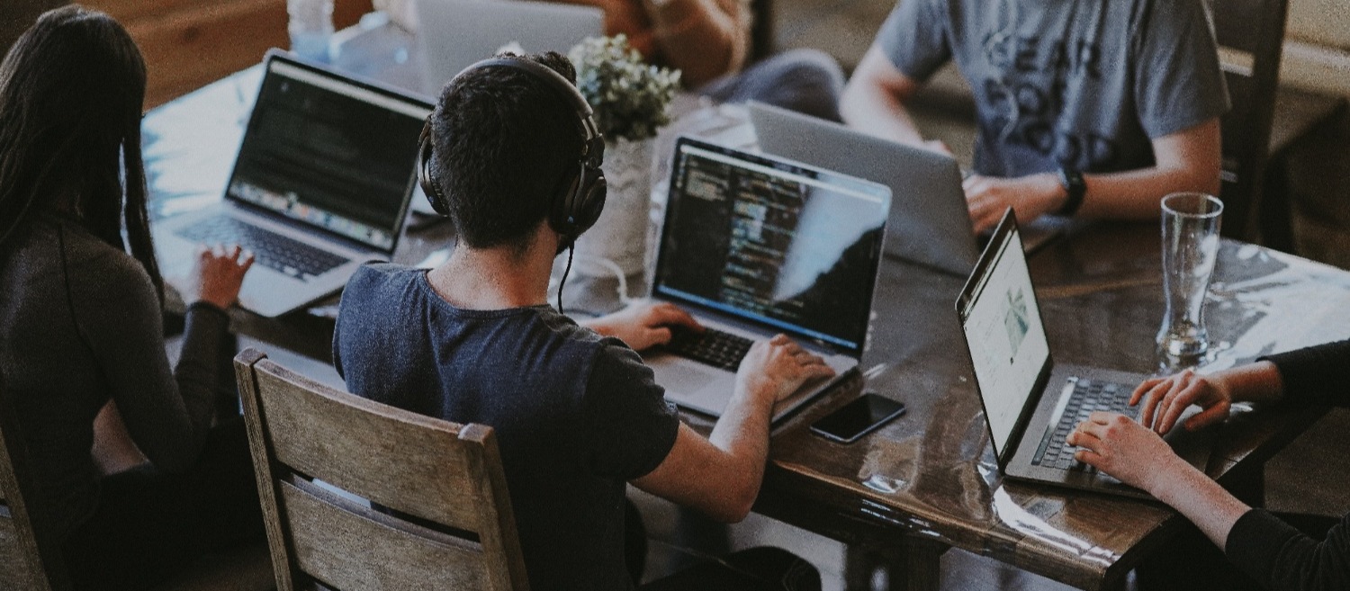 Shot of people working on individual laptops within a co-working space